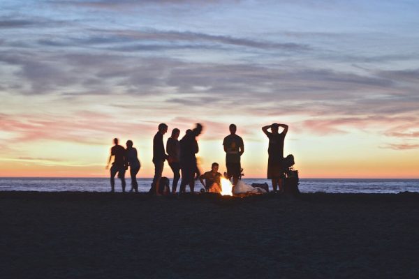 people enjoying a bon fire on the beach